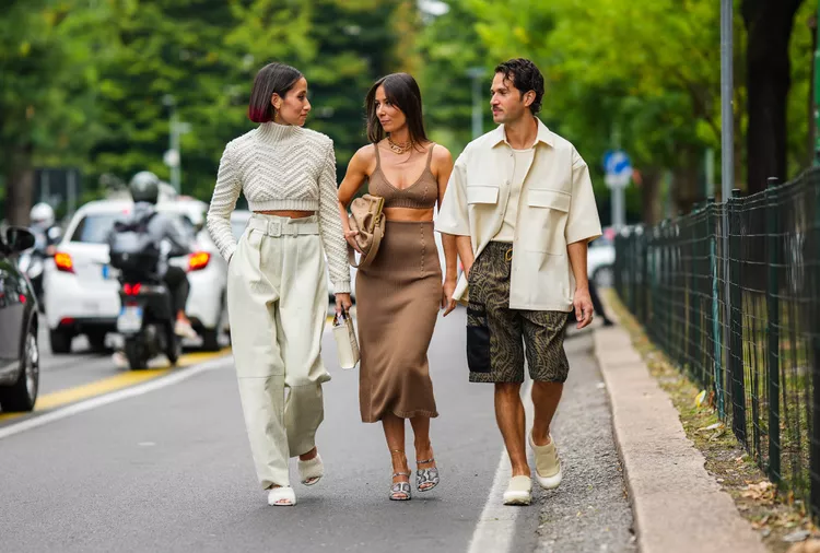 Three influencers walking together on a city street.