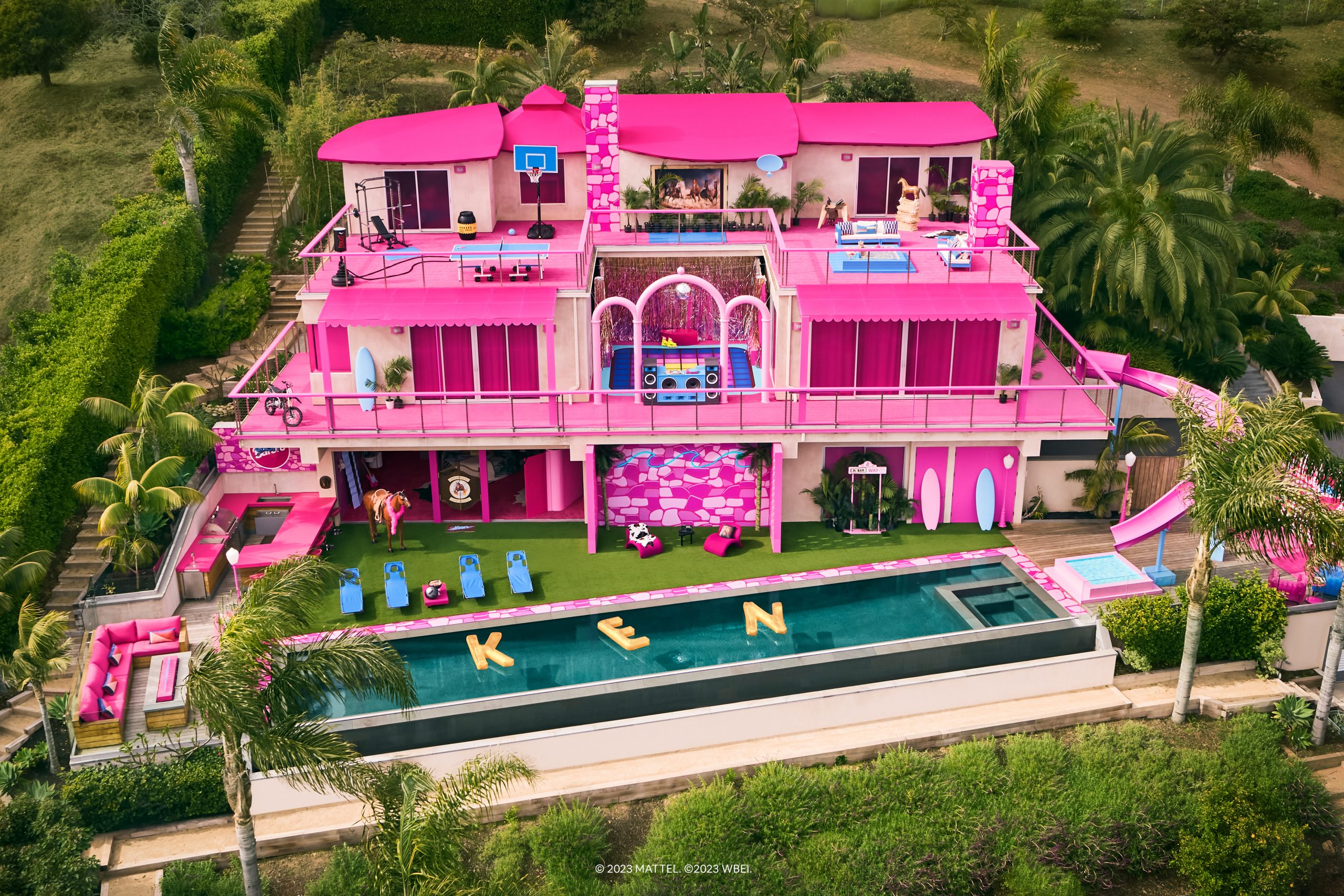 Barbie-themed pink mansion with pool and decorations, used as a promotional Airbnb experience for the Barbie movie.