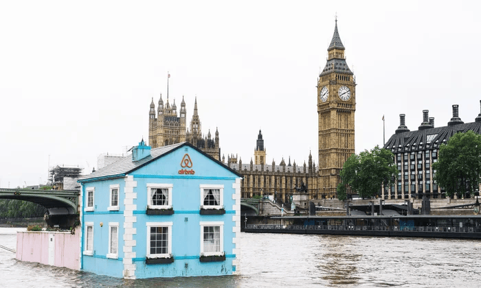 Airbnb sails a full-size floating house along the river Thames in London.