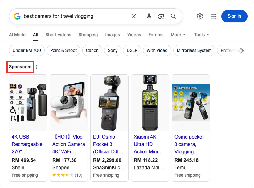 Search engine marketing example with Google search results displaying sponsored product ads for cameras.