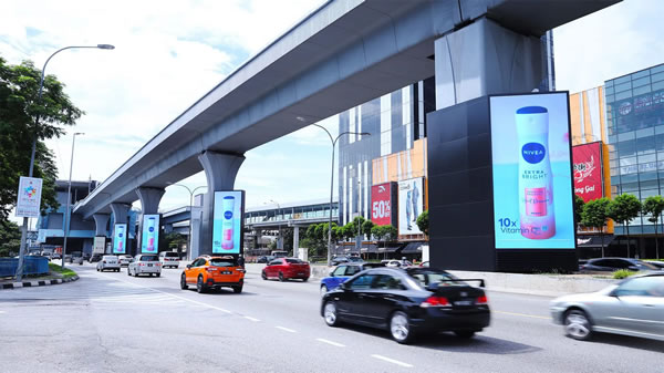Digital out-of-home ads on roadside screens reaching drivers and commuters.