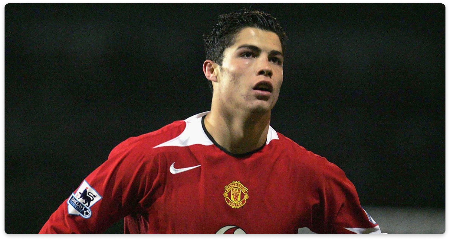 Footballer wearing a red jersey with a Nike logo during a match.